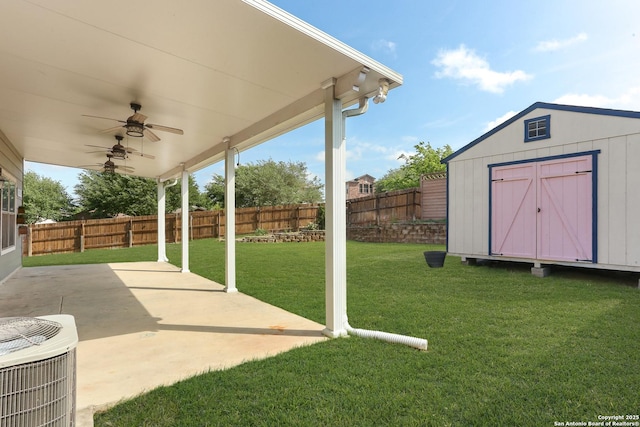 view of yard featuring a storage shed, a fenced backyard, cooling unit, a patio area, and an outdoor structure