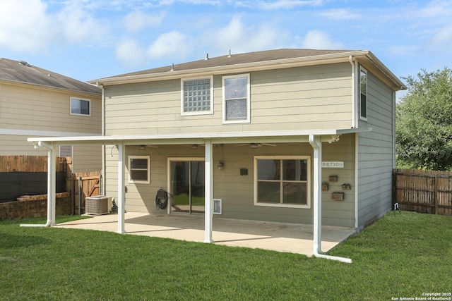 back of house with fence, a ceiling fan, a patio area, and a yard