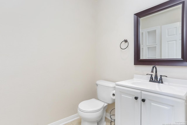 bathroom with baseboards, toilet, vanity, and tile patterned floors