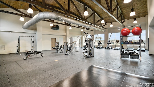 workout area with wood ceiling, high vaulted ceiling, and visible vents