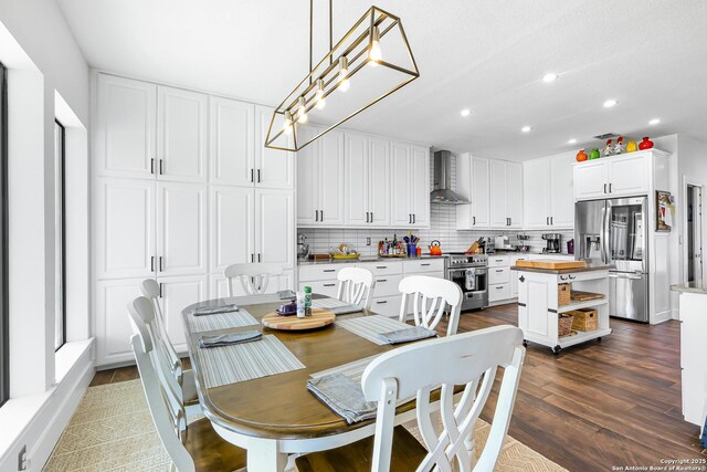 dining space featuring dark wood-type flooring and recessed lighting
