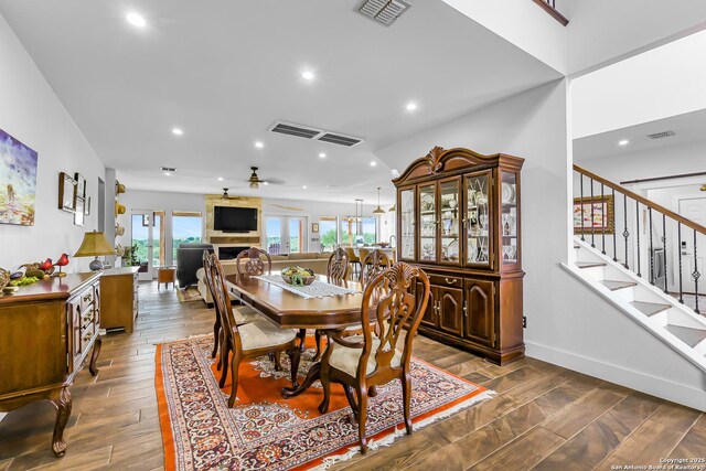 dining room featuring stairway, wood finished floors, visible vents, and recessed lighting