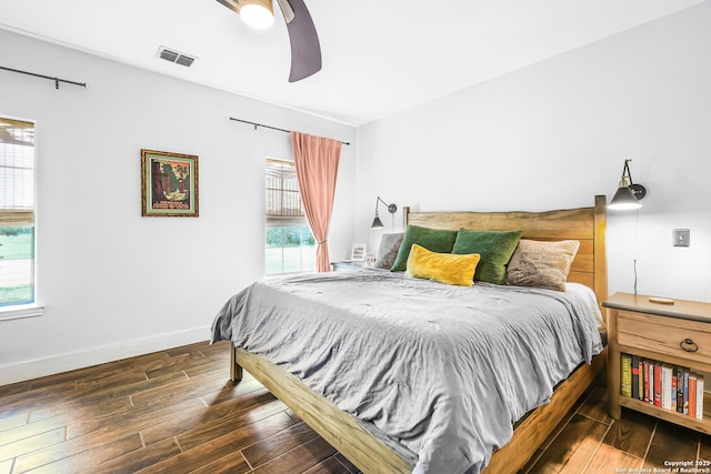 bedroom featuring multiple windows, wood finished floors, and visible vents