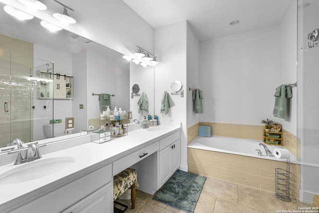 full bathroom featuring a bath, a sink, double vanity, and a stall shower