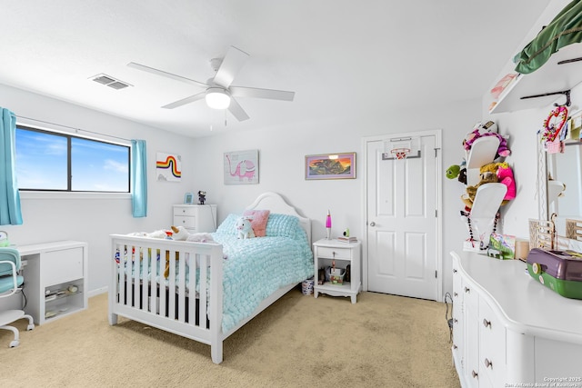 bedroom with light colored carpet, a ceiling fan, and visible vents