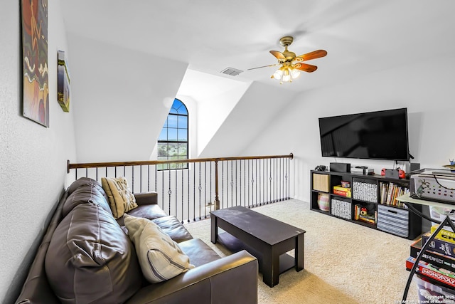 living room featuring vaulted ceiling, carpet flooring, visible vents, and a ceiling fan