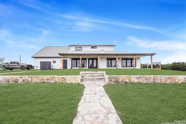 view of front of property with a front lawn and metal roof