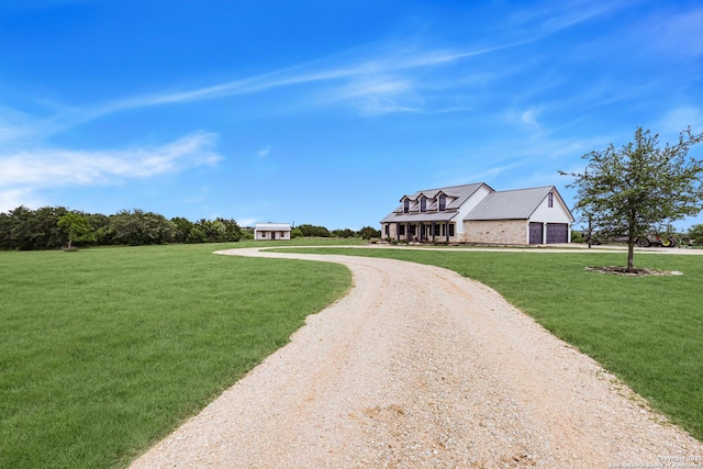 surrounding community with a lawn, dirt driveway, and a garage