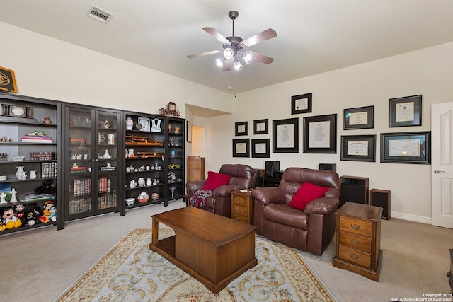 carpeted living room with baseboards, a ceiling fan, and visible vents