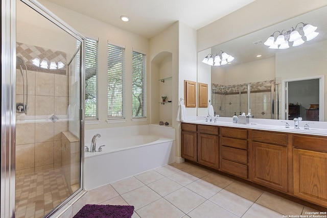 full bathroom with a bath, a sink, double vanity, and a stall shower