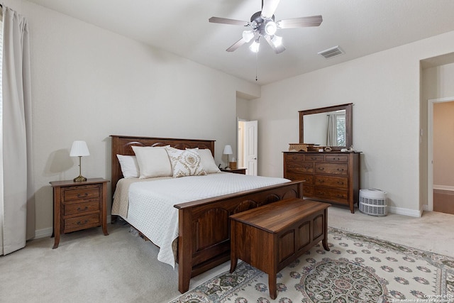 bedroom featuring light carpet, a ceiling fan, visible vents, and baseboards