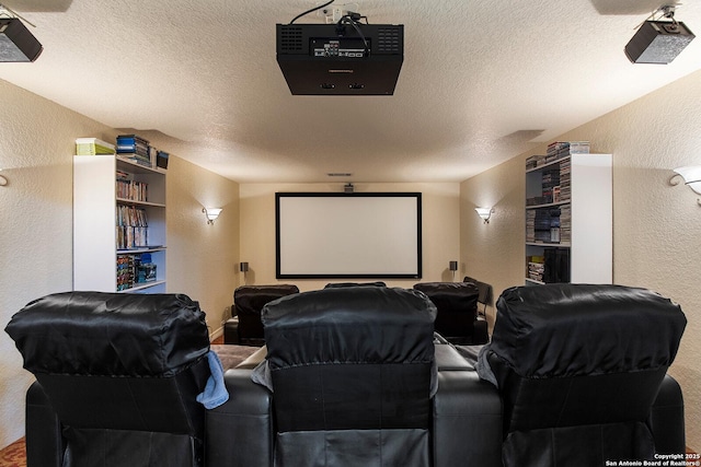 home theater room with a textured wall and a textured ceiling