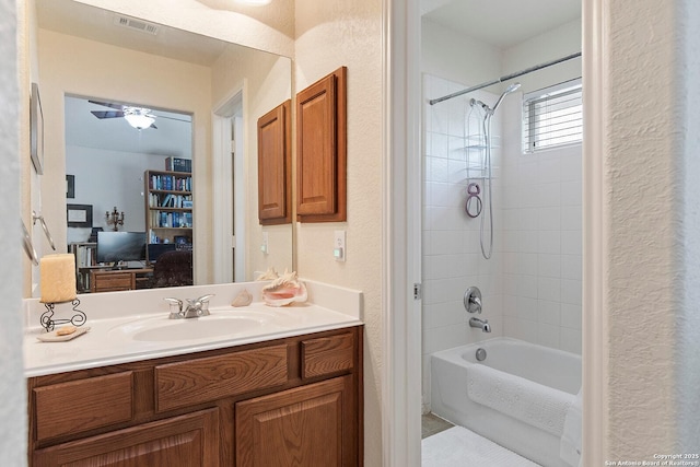 bathroom featuring tile patterned floors, vanity, bathtub / shower combination, a textured wall, and visible vents