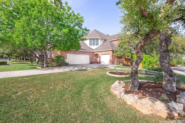 view of front of house with brick siding, an attached garage, a front yard, and concrete driveway