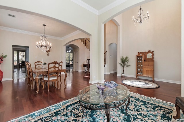 interior space with arched walkways, wood finished floors, visible vents, and a notable chandelier