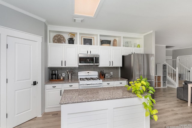 21707 Beaver Bnd, San Antonio, TX 78258 - kitchen featuring white cabinetry, appliances with stainless steel finishes, and crown molding