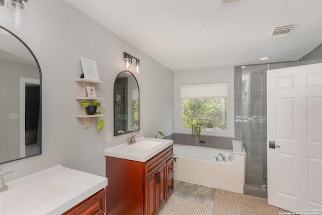 21707 Beaver Bnd, San Antonio, TX 78258 - bathroom featuring a garden tub, visible vents, a sink, and a stall shower