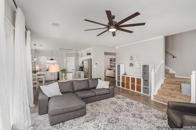 21707 Beaver Bnd, San Antonio, TX 78258 - living room with wood finished floors, visible vents, stairs, and ceiling fan