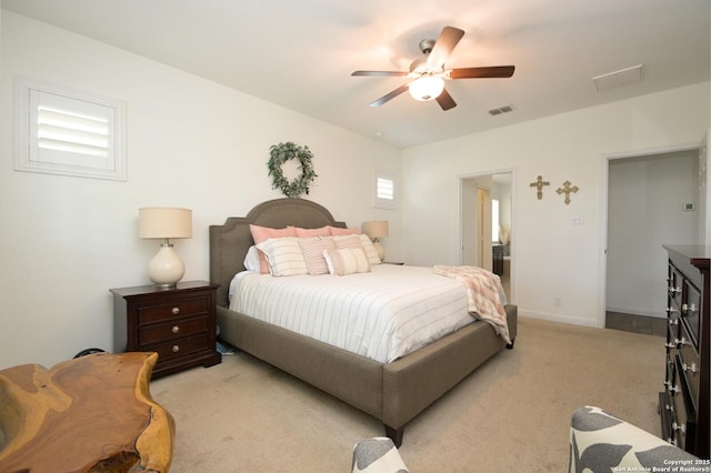 bedroom with light colored carpet, baseboards, a ceiling fan, and visible vents