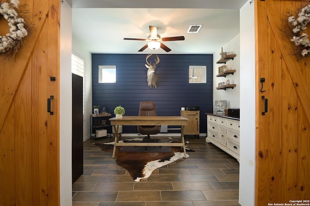 home office featuring a ceiling fan, visible vents, and wood tiled floor