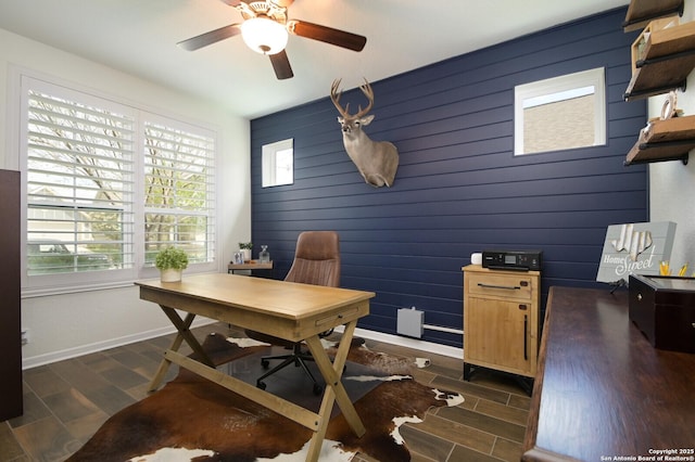 home office with plenty of natural light, baseboards, and dark wood-style flooring
