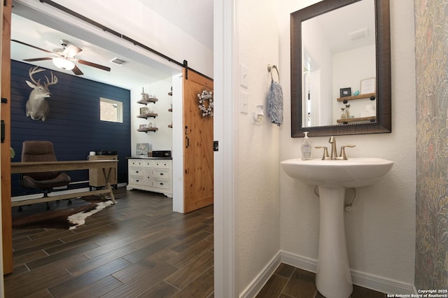 bathroom featuring baseboards, a ceiling fan, wood finished floors, and visible vents