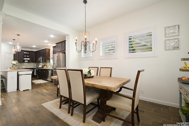 dining area with a chandelier, baseboards, dark wood-style flooring, and recessed lighting