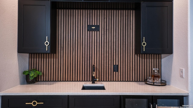 interior space with a textured wall and a sink