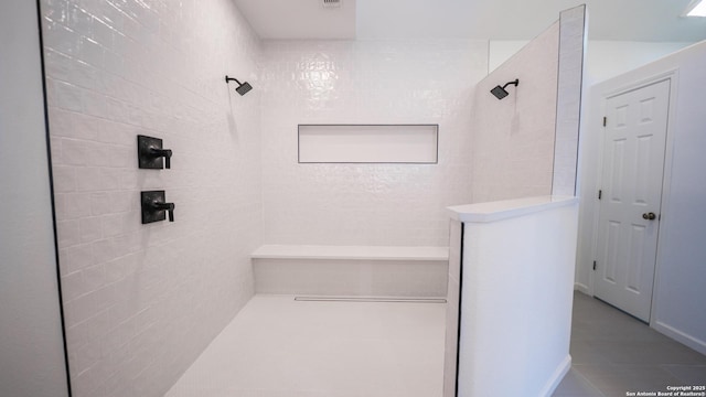 full bath featuring tile patterned flooring and a walk in shower