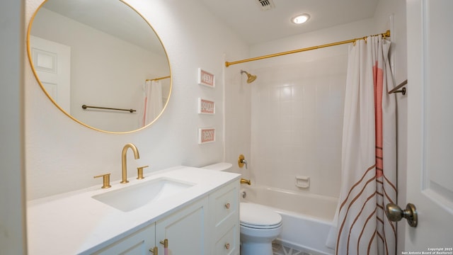 bathroom featuring shower / tub combo, toilet, vanity, and visible vents