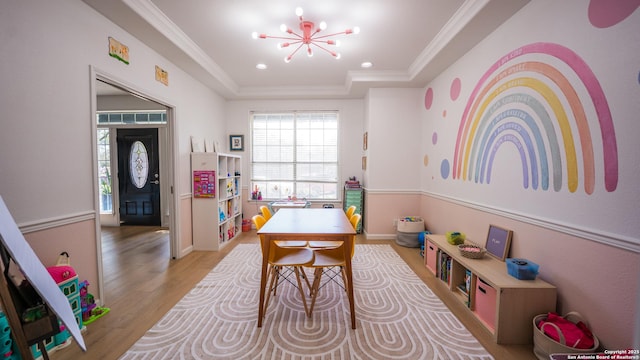 game room with crown molding, wood finished floors, a raised ceiling, a notable chandelier, and recessed lighting