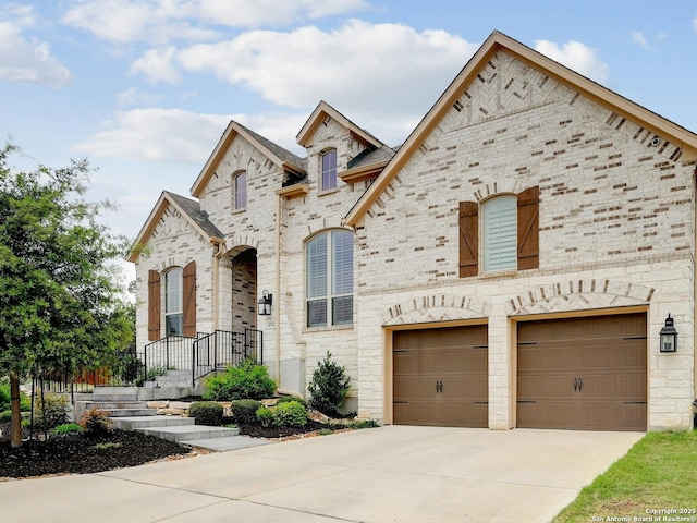24742 Para Siempre, San Antonio, TX 78261 - french country home featuring brick siding, driveway, and a garage