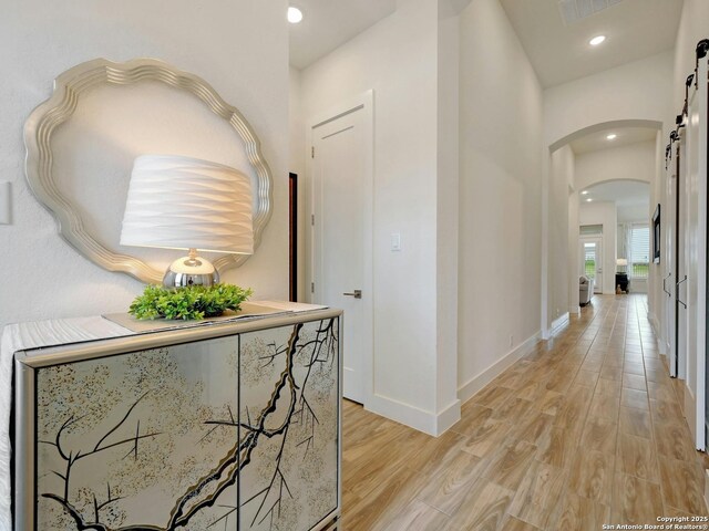 24742 Para Siempre, San Antonio, TX 78261 - hallway featuring visible vents, light wood-style floors, baseboards, recessed lighting, and arched walkways