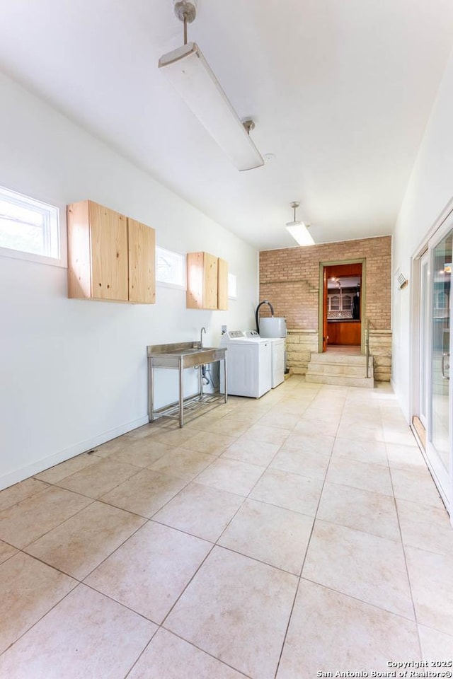 laundry area with plenty of natural light, laundry area, and light tile patterned flooring