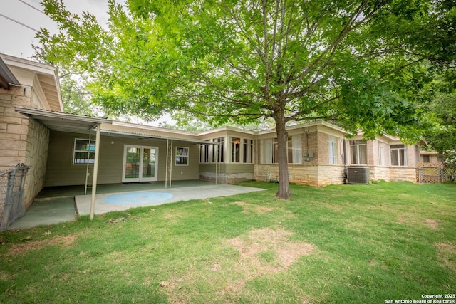 rear view of property featuring a lawn, a patio, and cooling unit