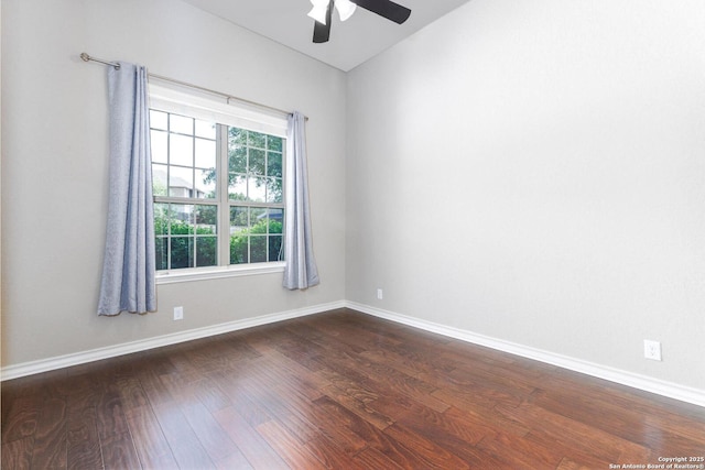 spare room featuring dark wood finished floors, baseboards, and a ceiling fan
