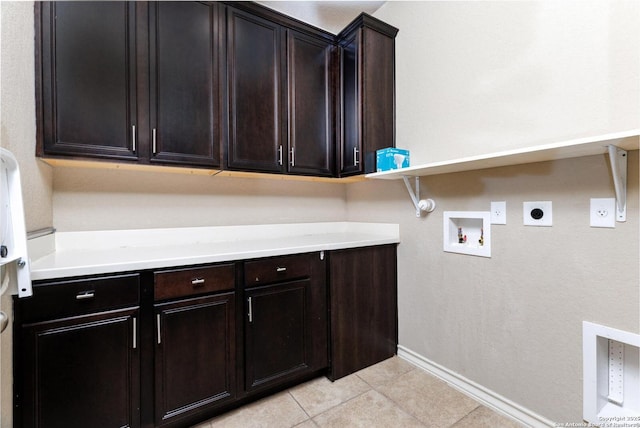 clothes washing area with light tile patterned floors, hookup for a gas dryer, electric dryer hookup, cabinet space, and washer hookup