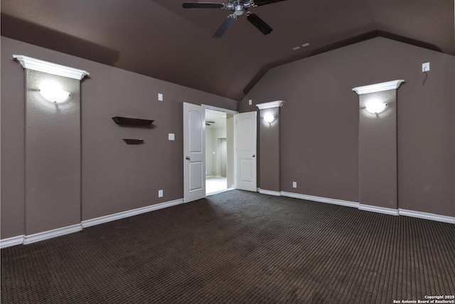 carpeted spare room featuring lofted ceiling, a ceiling fan, and baseboards