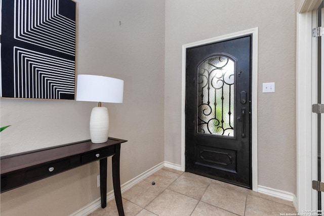 entrance foyer featuring baseboards and light tile patterned flooring
