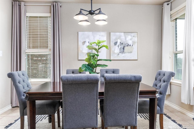 dining area with plenty of natural light, baseboards, a notable chandelier, and light tile patterned floors