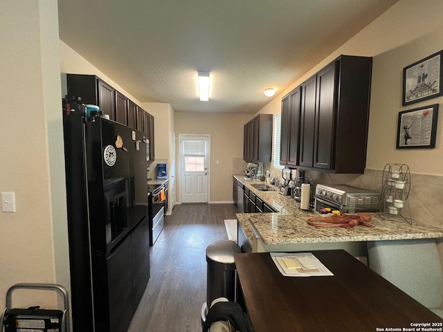 kitchen with a sink, black fridge with ice dispenser, electric range, dark wood finished floors, and a peninsula