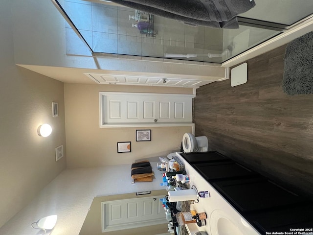 kitchen featuring visible vents and wood walls