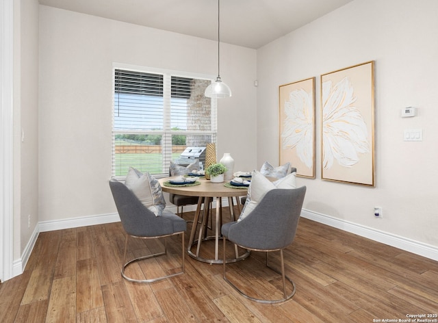 dining room featuring baseboards and wood finished floors