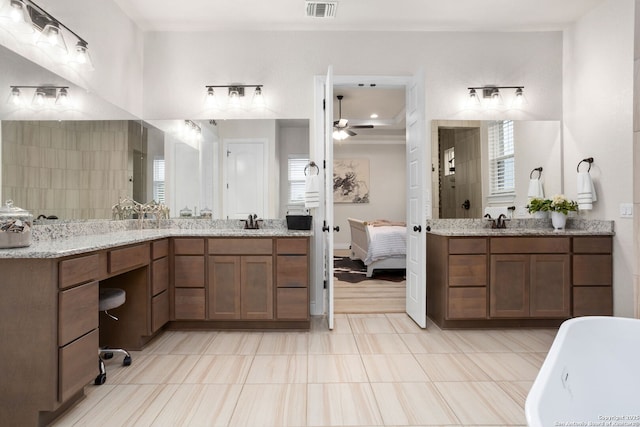 full bathroom with a sink, a tile shower, visible vents, a ceiling fan, and a freestanding tub