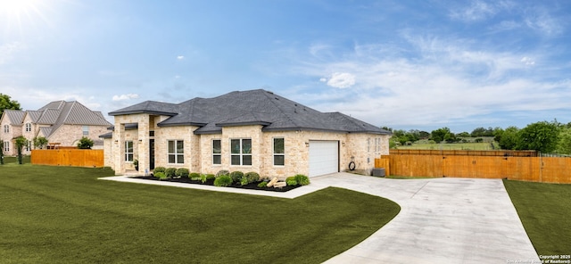 french country home featuring driveway, stone siding, a front yard, and fence