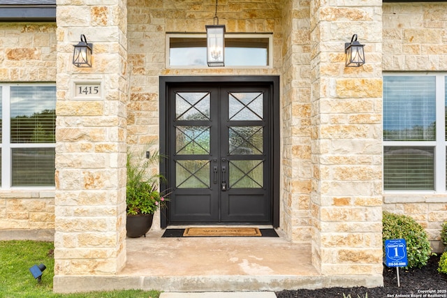 doorway to property with french doors and stone siding