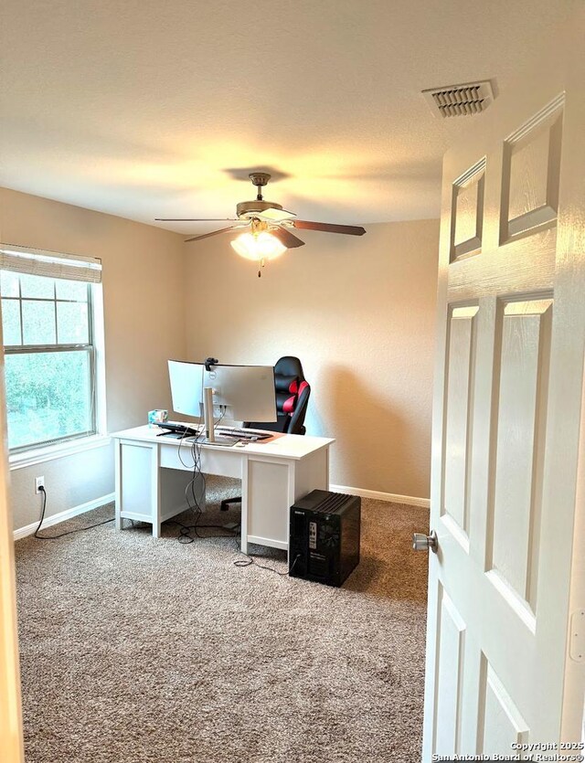 carpeted office featuring ceiling fan, baseboards, and visible vents