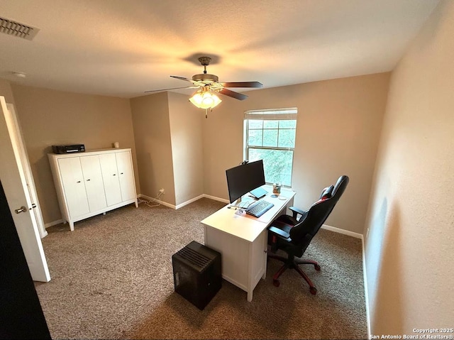 home office with carpet floors, visible vents, baseboards, and ceiling fan