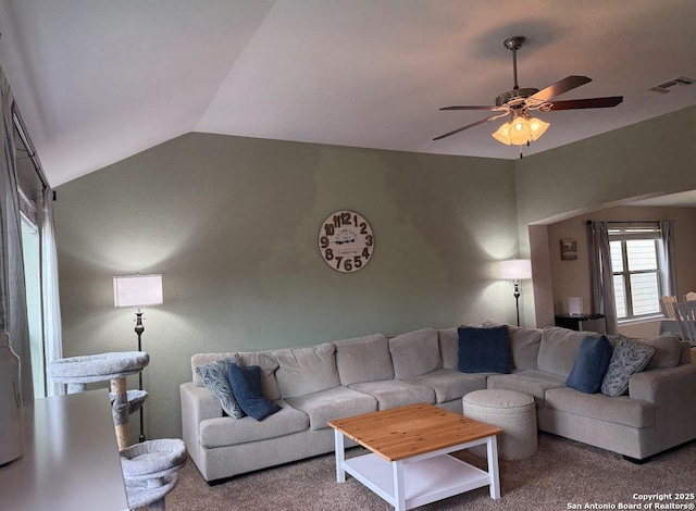 carpeted living area featuring a ceiling fan, visible vents, and vaulted ceiling