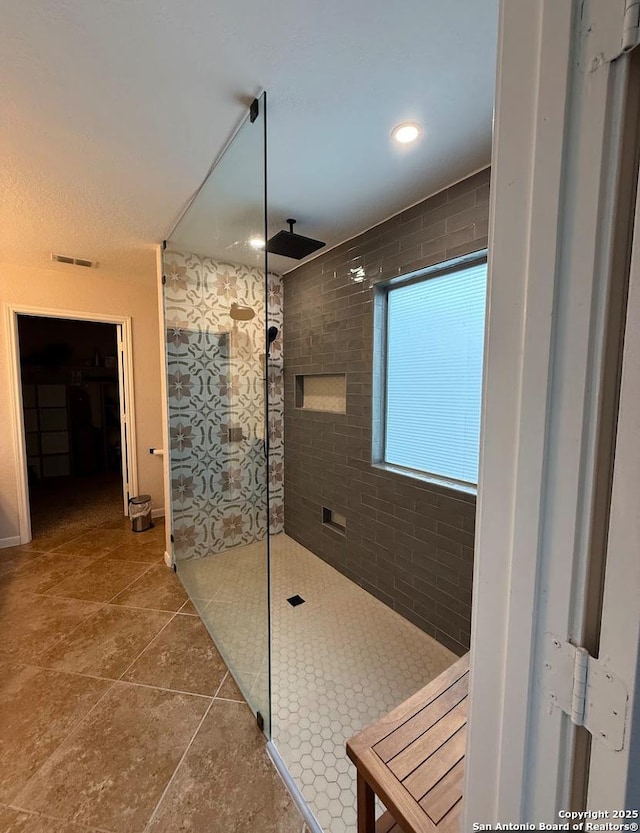 bathroom with walk in shower and visible vents